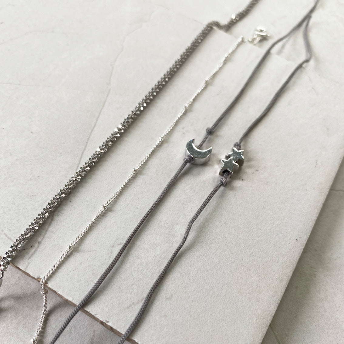 Silver charm threaded bracelet